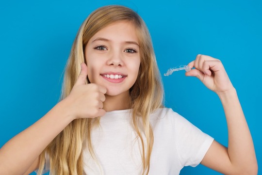 インビザライン・ファーストを手に持った女の子